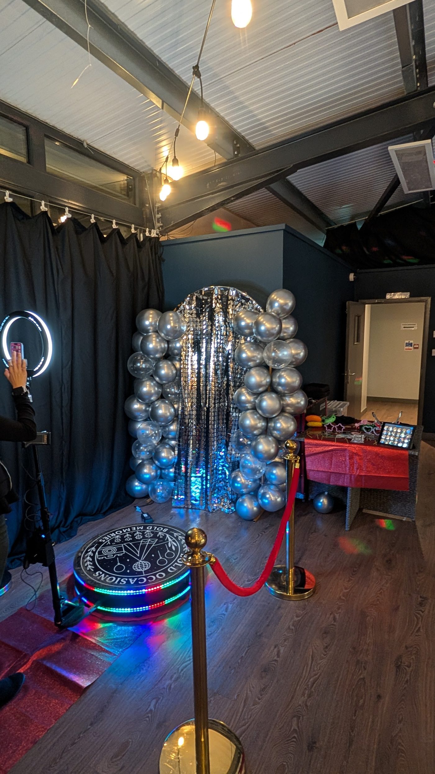 360 booth with silver balloons and sequin backdrop